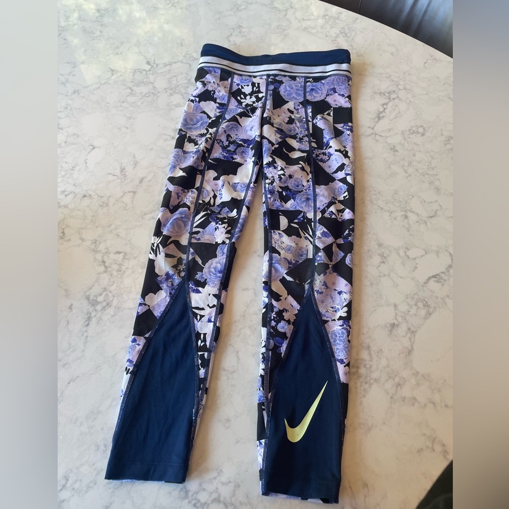It is a purple and flower with black sand a neon green Nike symbols